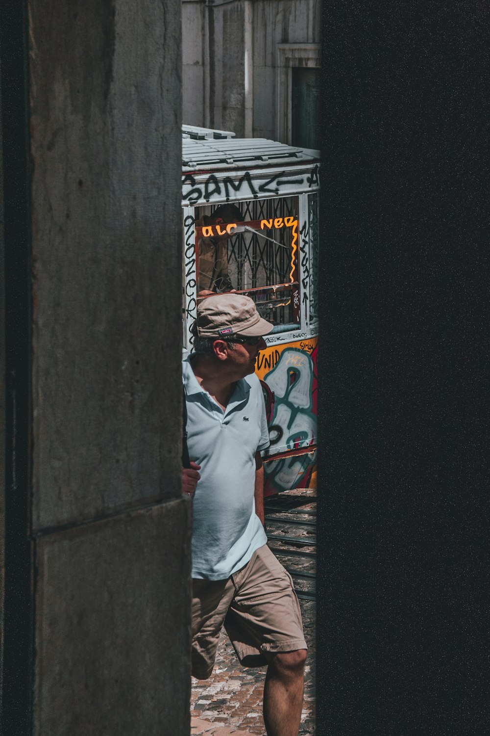 man in blue polo shirt standing