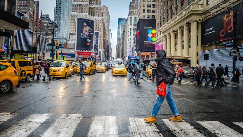 man crossing on the street during daytime