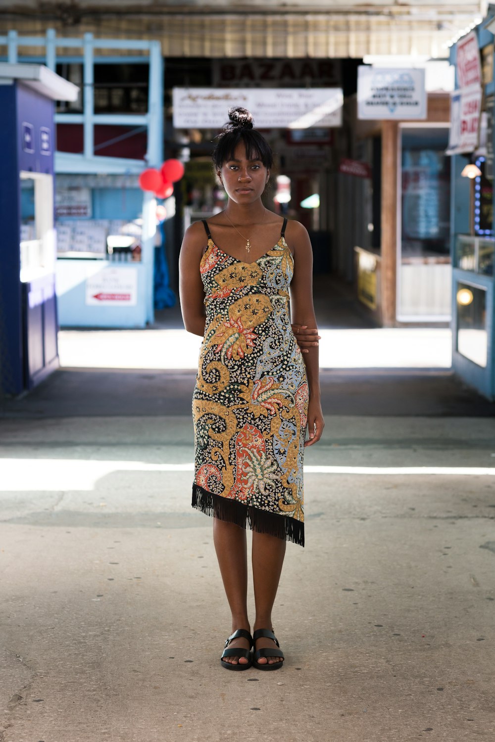 woman in yellow and black spaghetti strap dress