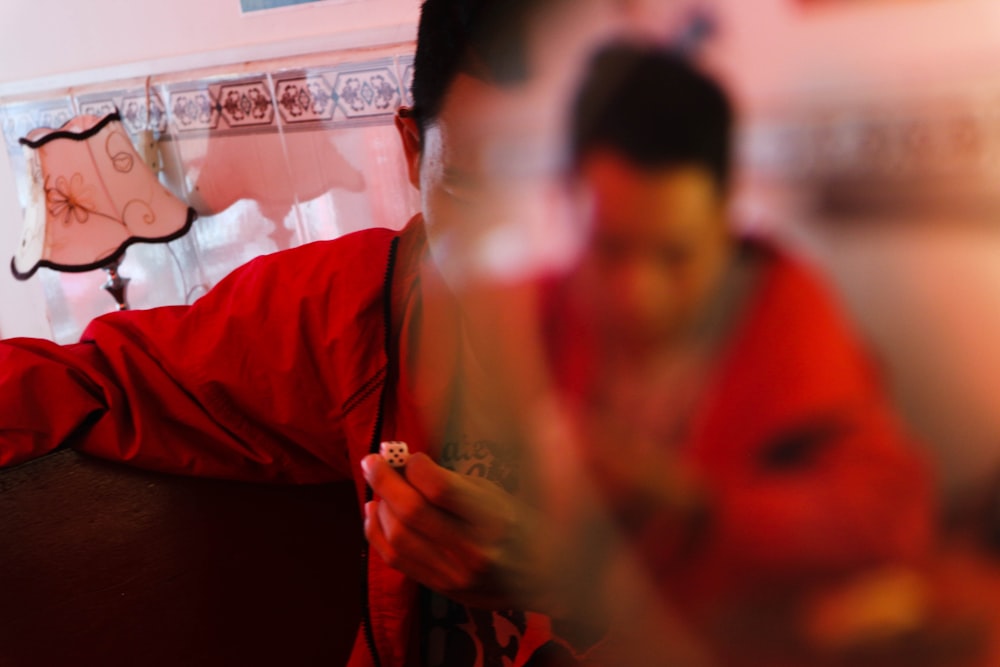 man in red jacket sitting