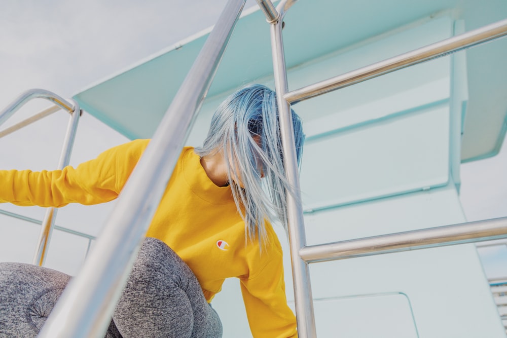 woman in yellow Champion crew-neck long-sleeved shirt