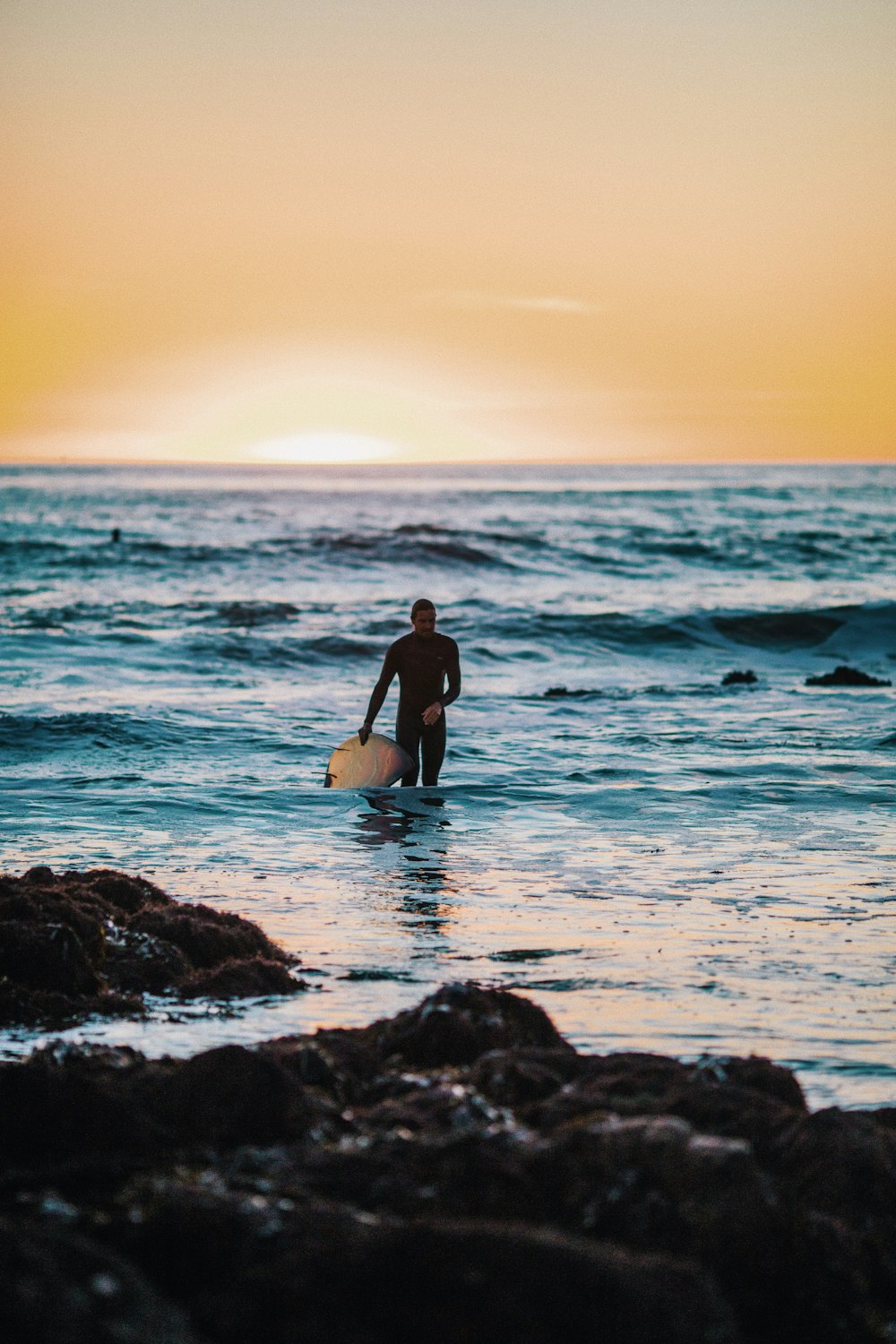 man holding surfboard at beach during daytime