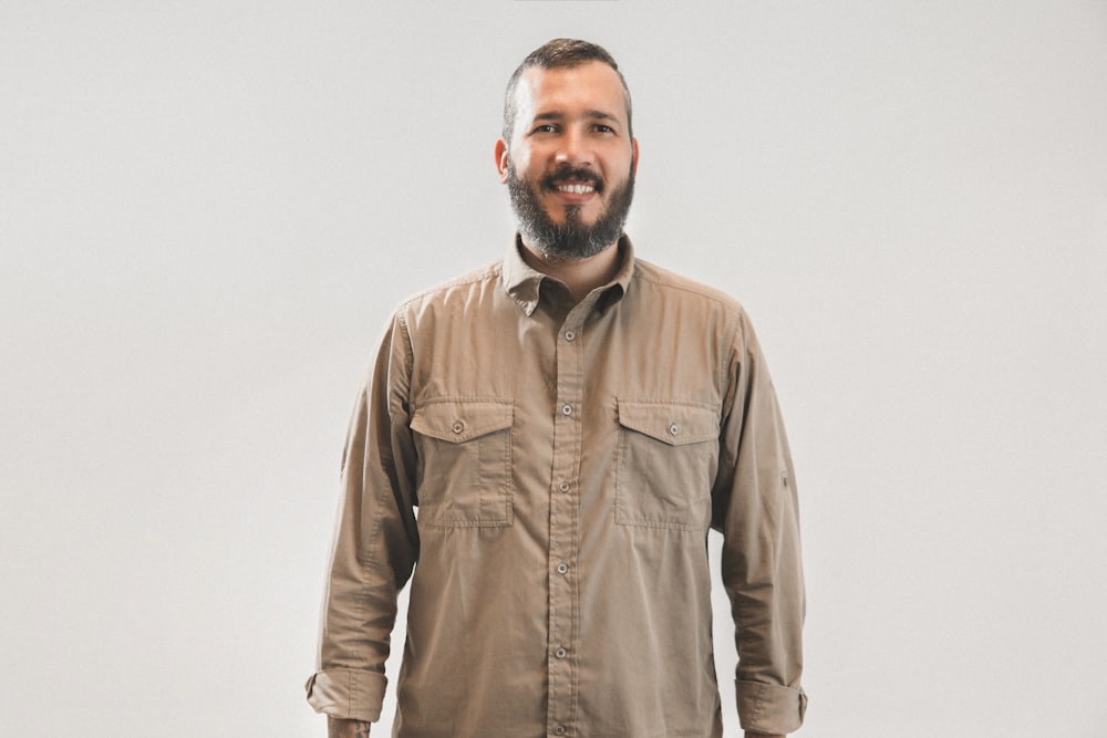 smiling man in brown dress shirt on focus photography