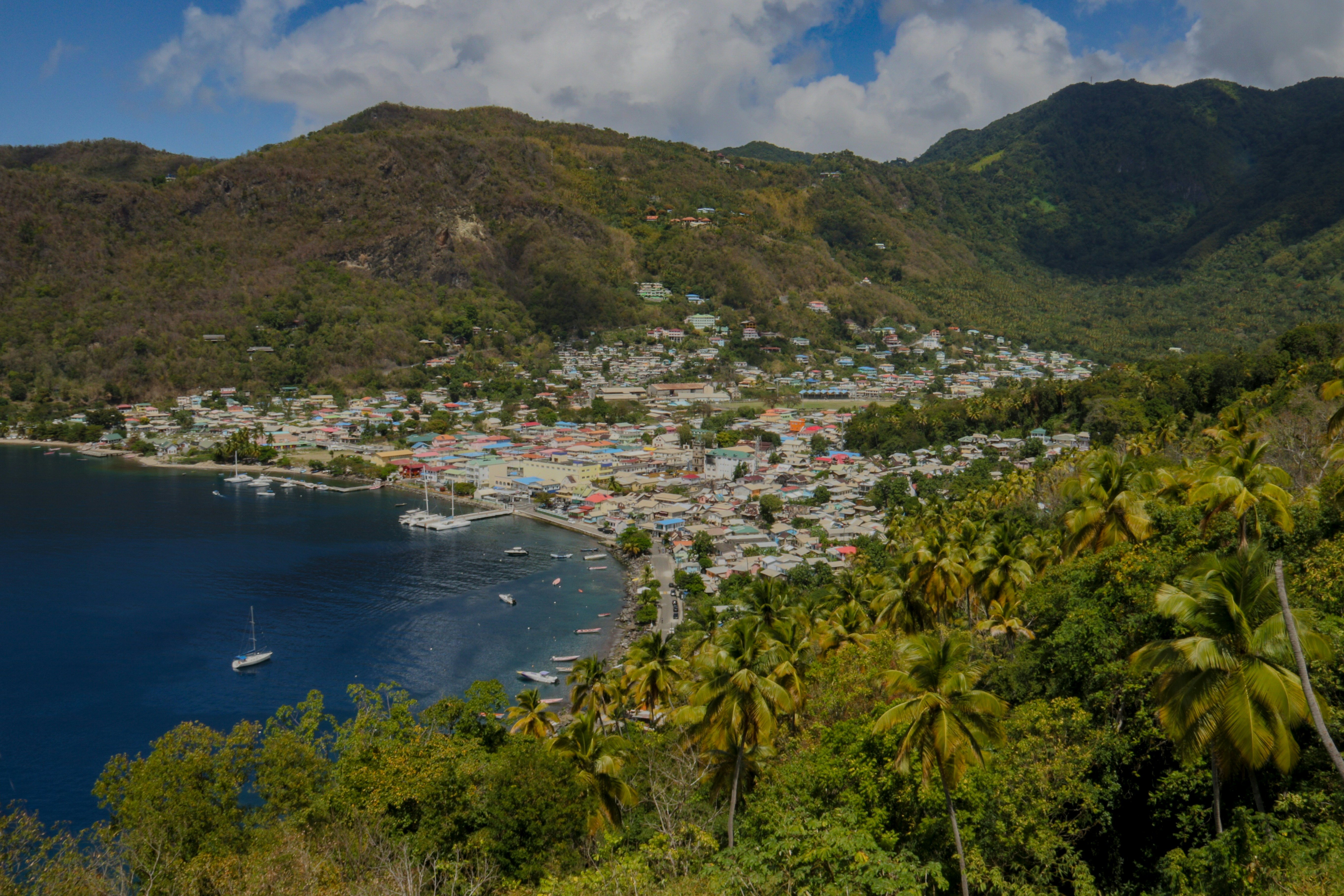 calm body of water near the city during daytime st. lucia teams background