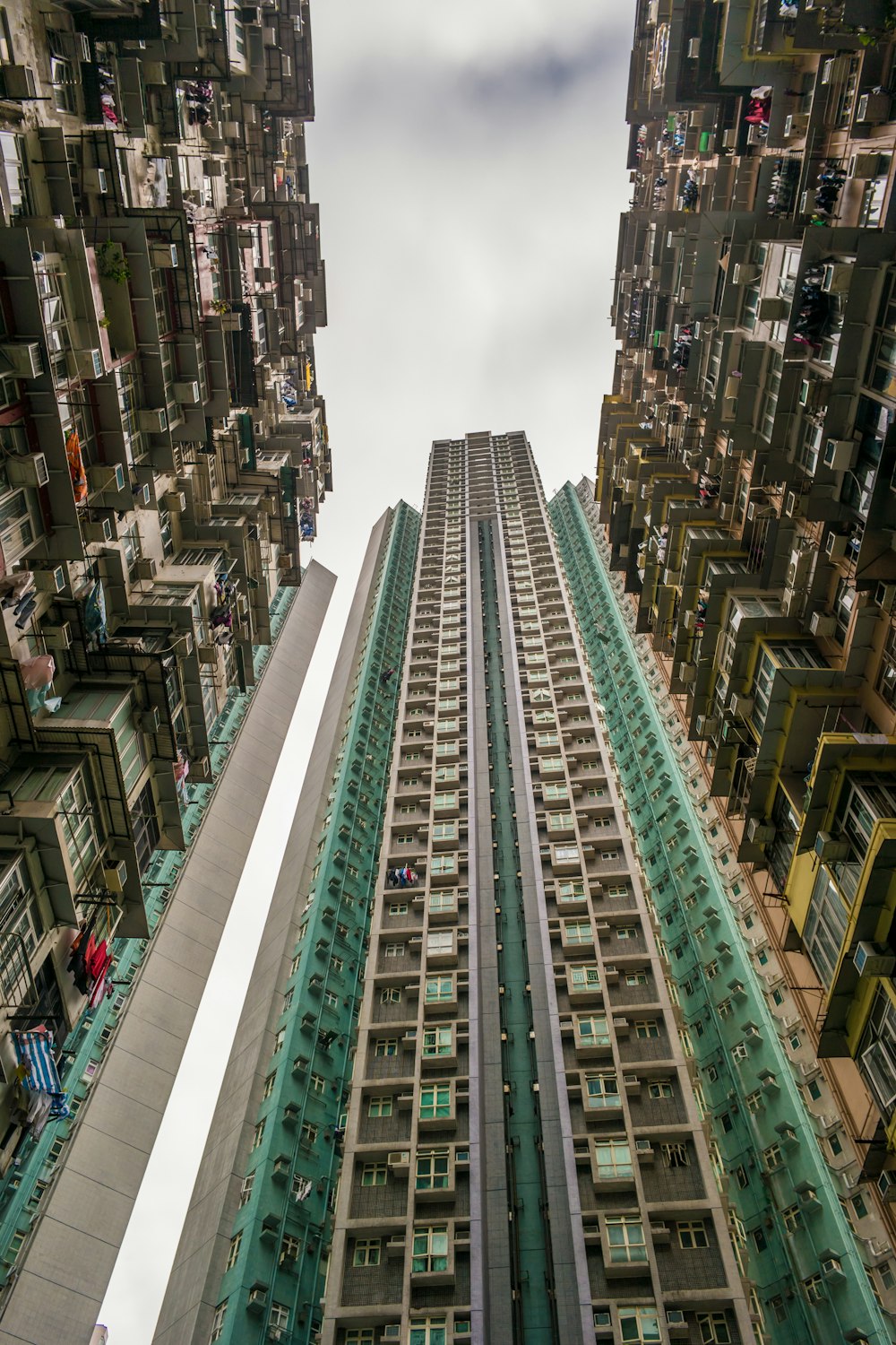 low-angle photography of green and white concrete building during daytime