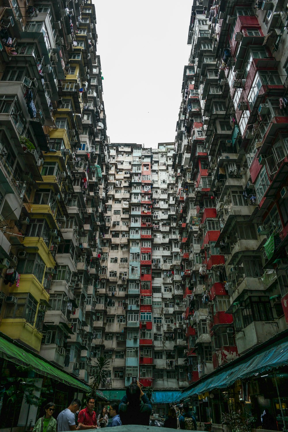 people standing outside high-rise building during daytime