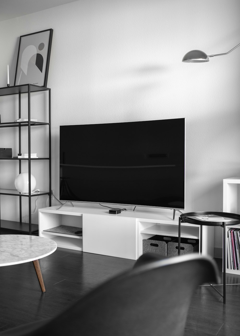 flat screen television on top of white wooden low-line TV stand