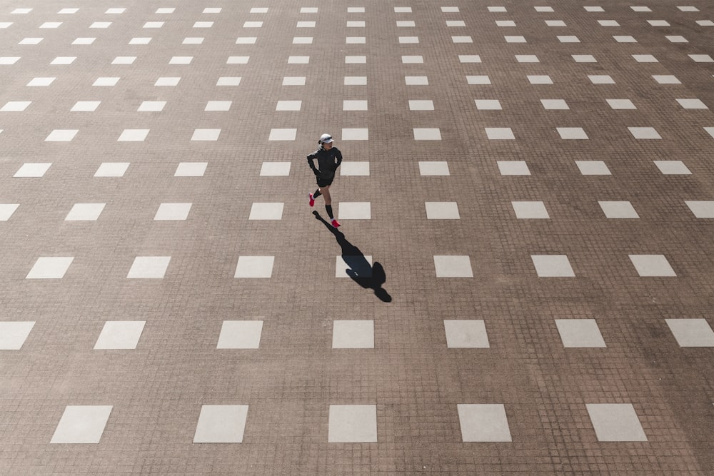 woman runs on grey and white field