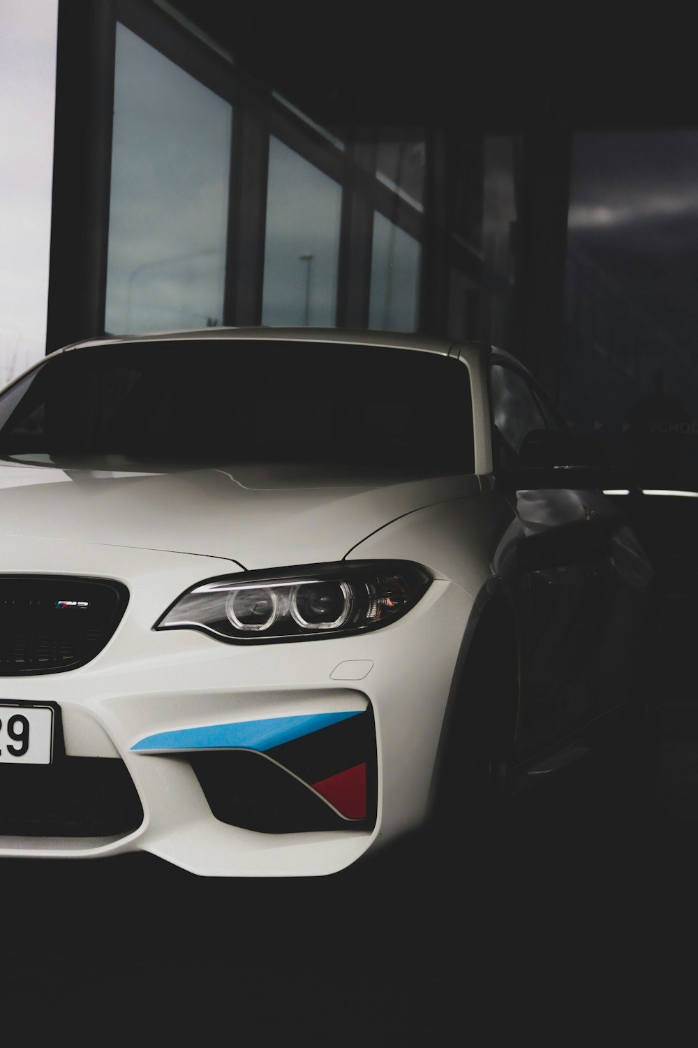 white BMW M sport parked inside building