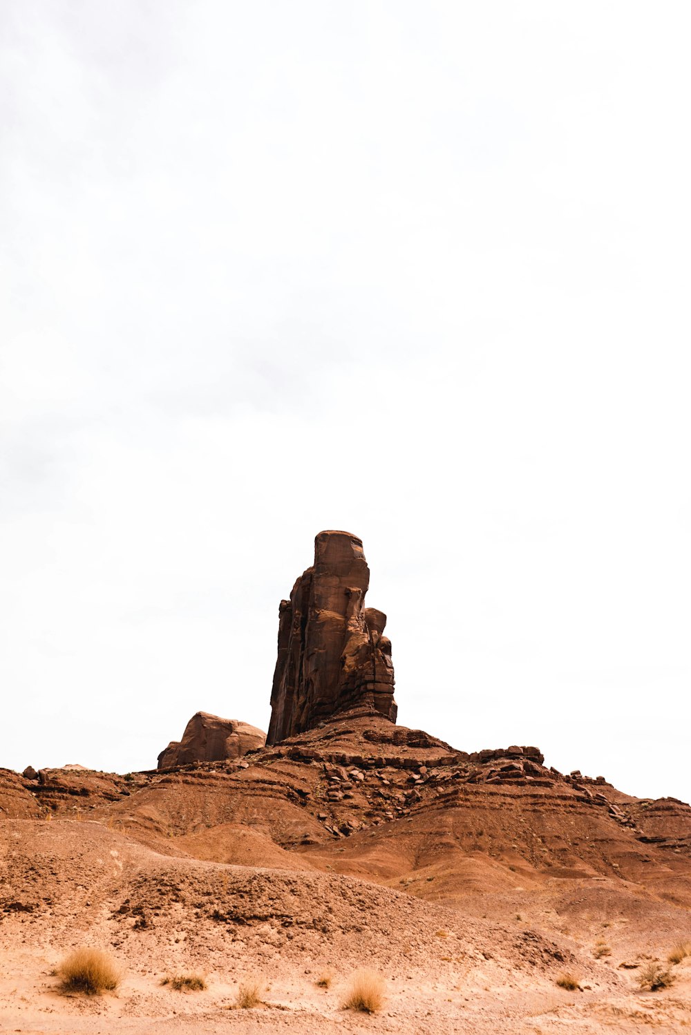 brown rock formation under white sky