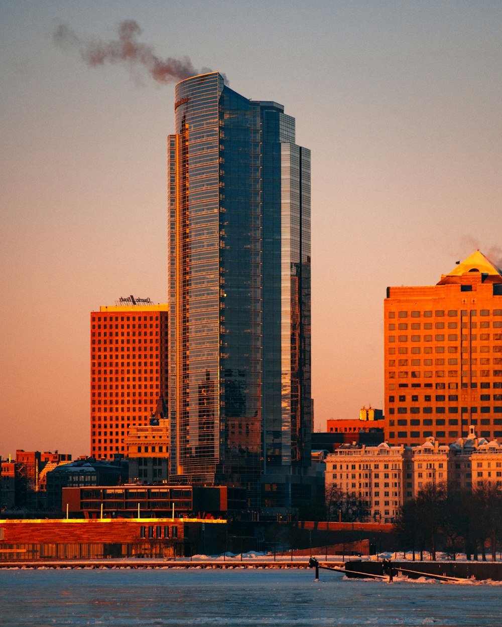 high rise building beside blue body of water