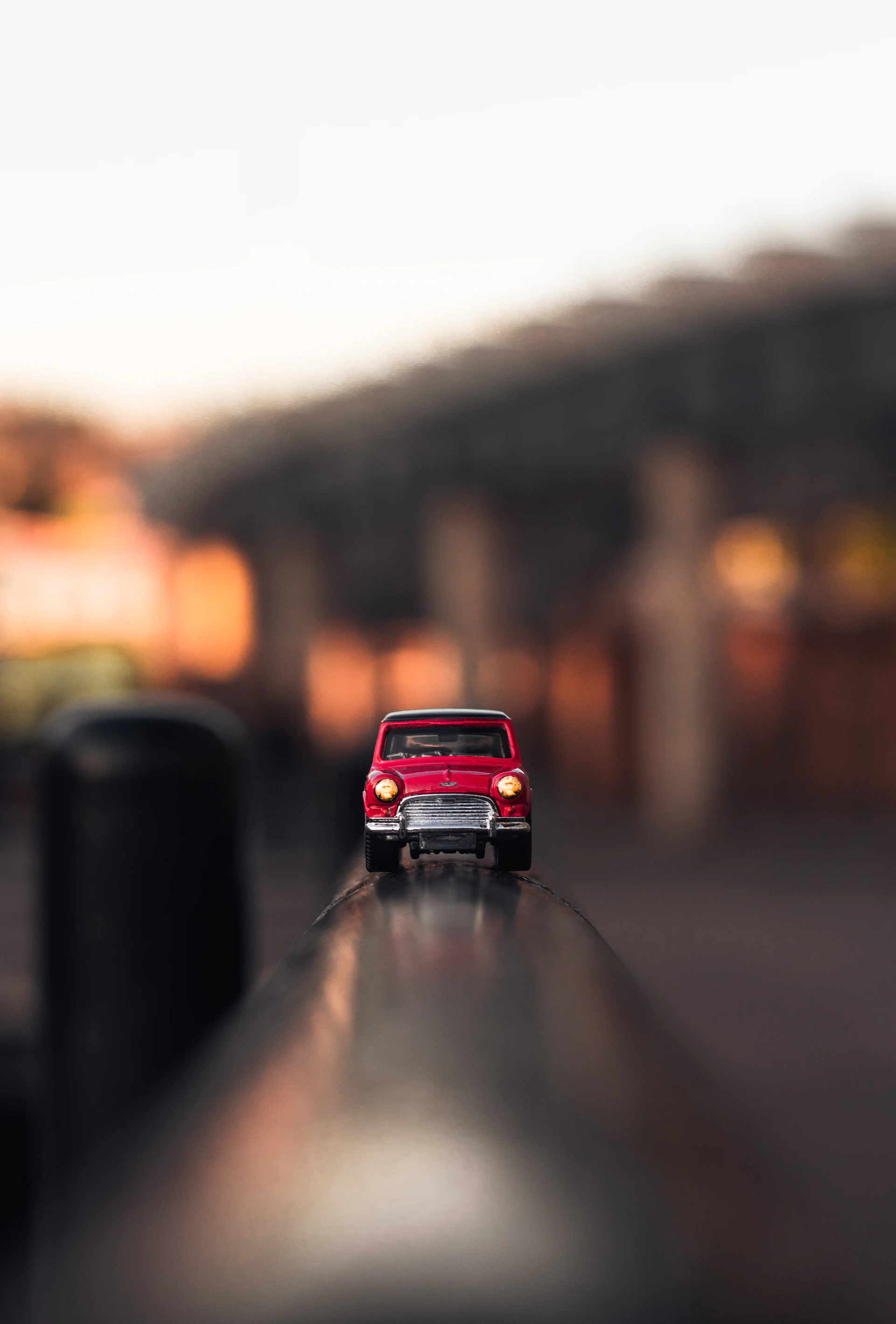 shallow focus photography of red die-cast car
