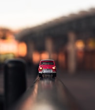 shallow focus photography of red die-cast car