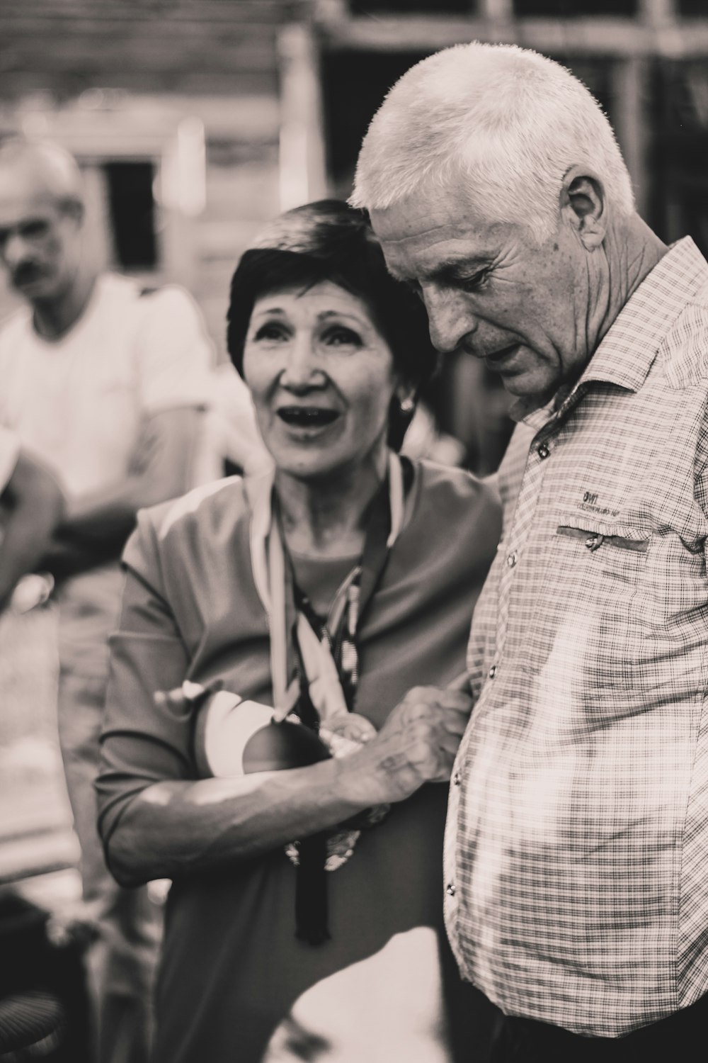 grayscale photography of woman standing beside man