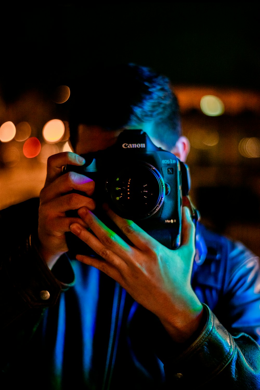 man taking a photo using black Canon DLSR camera