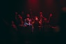 group of person singing on dark ara