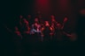 group of person singing on dark ara