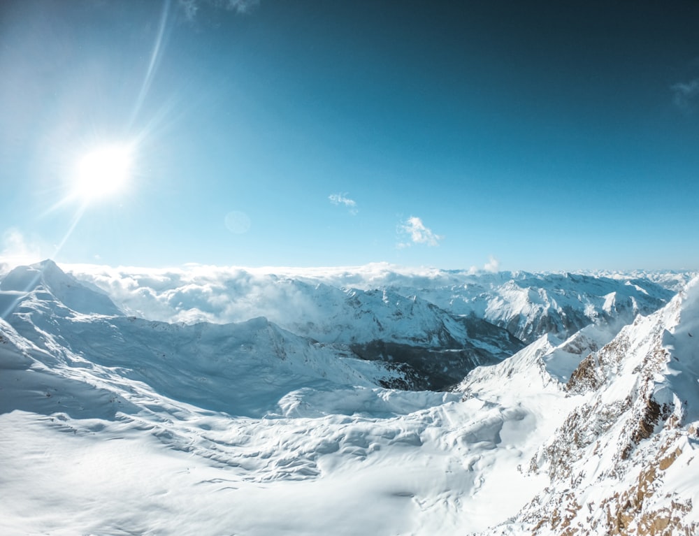 mountian range covered by snow during daytime