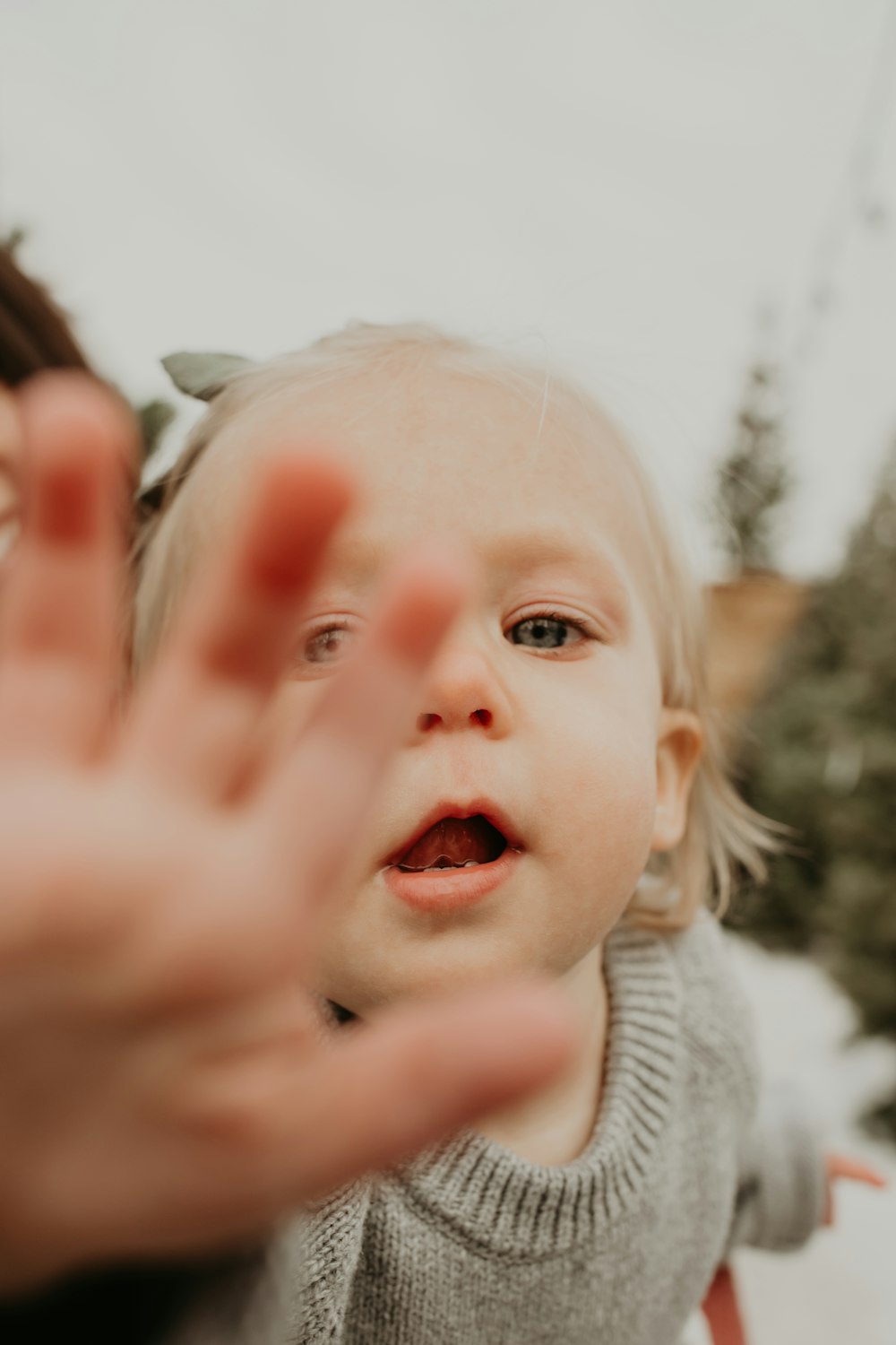 girl in gray knit top on selective focus photography