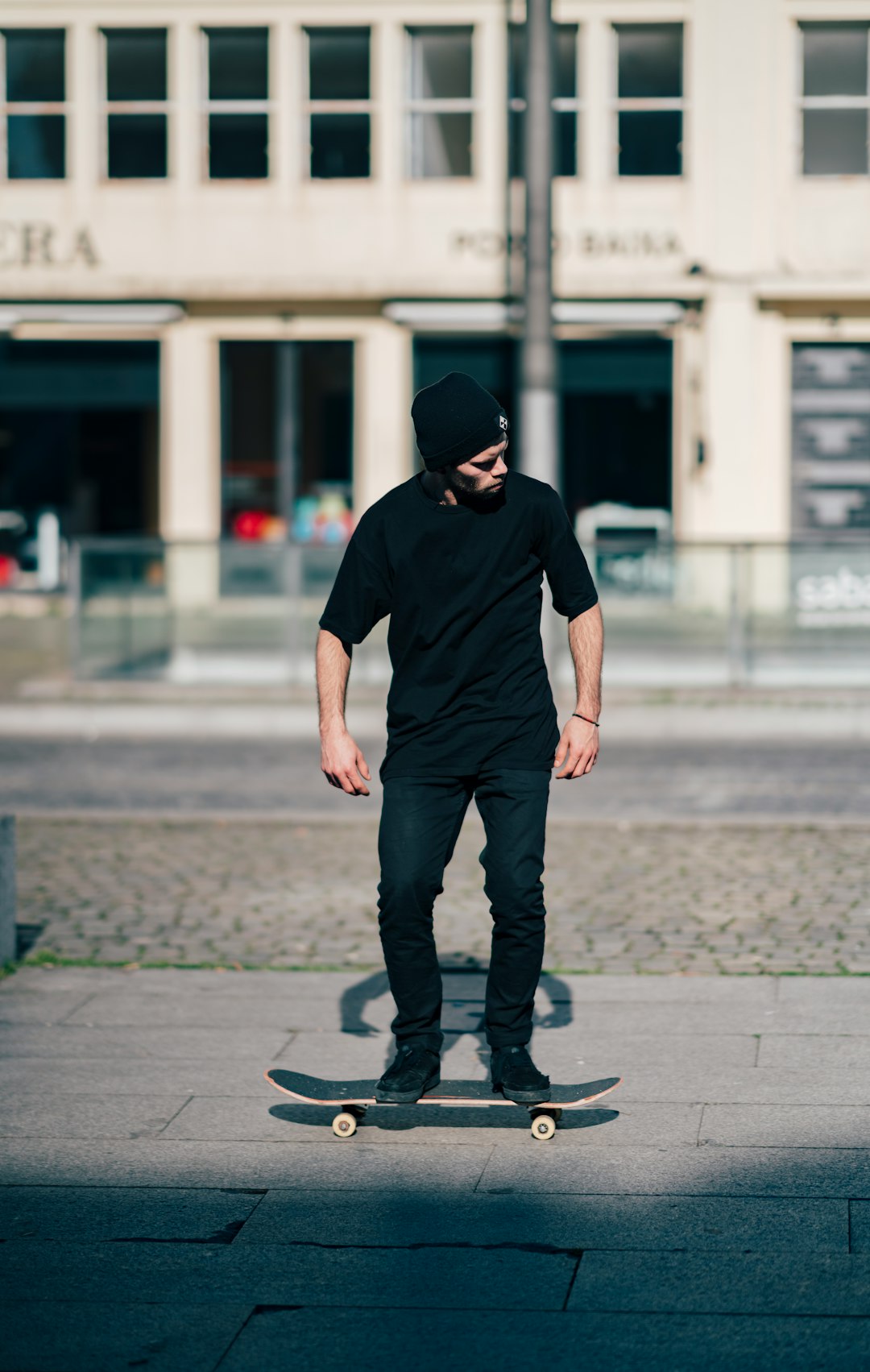 man in black shirt skating on pathway