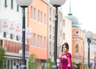 woman standing beside black and white street post