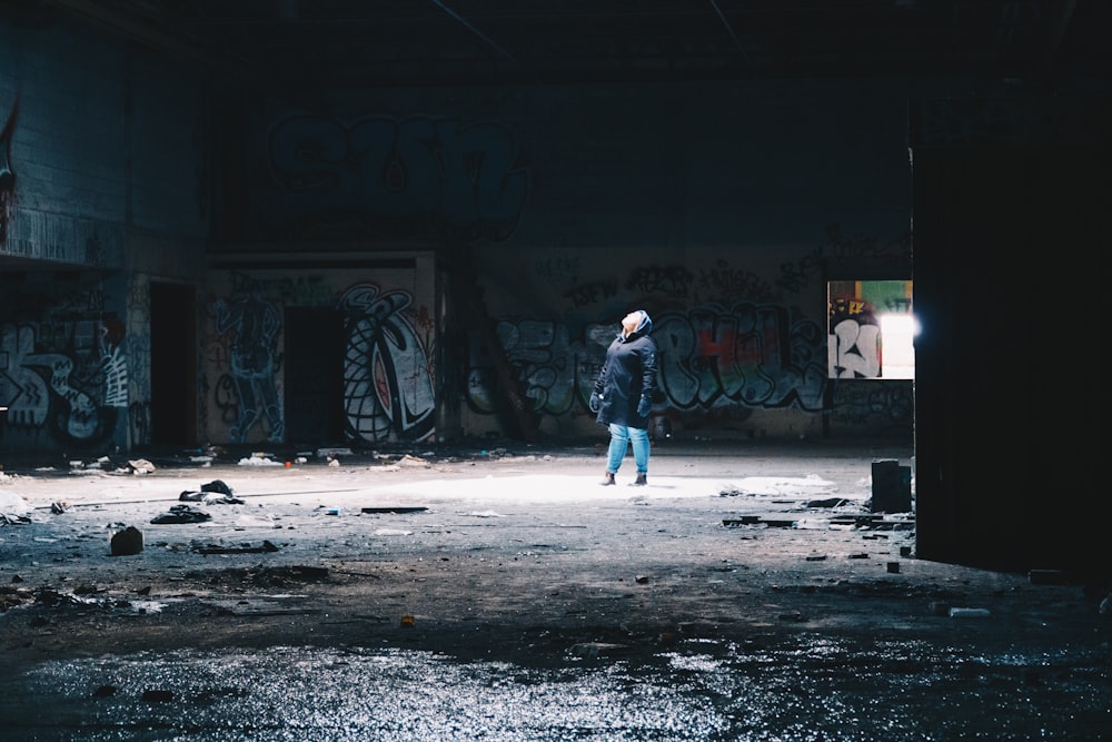 woman wearing blue jacket inside building