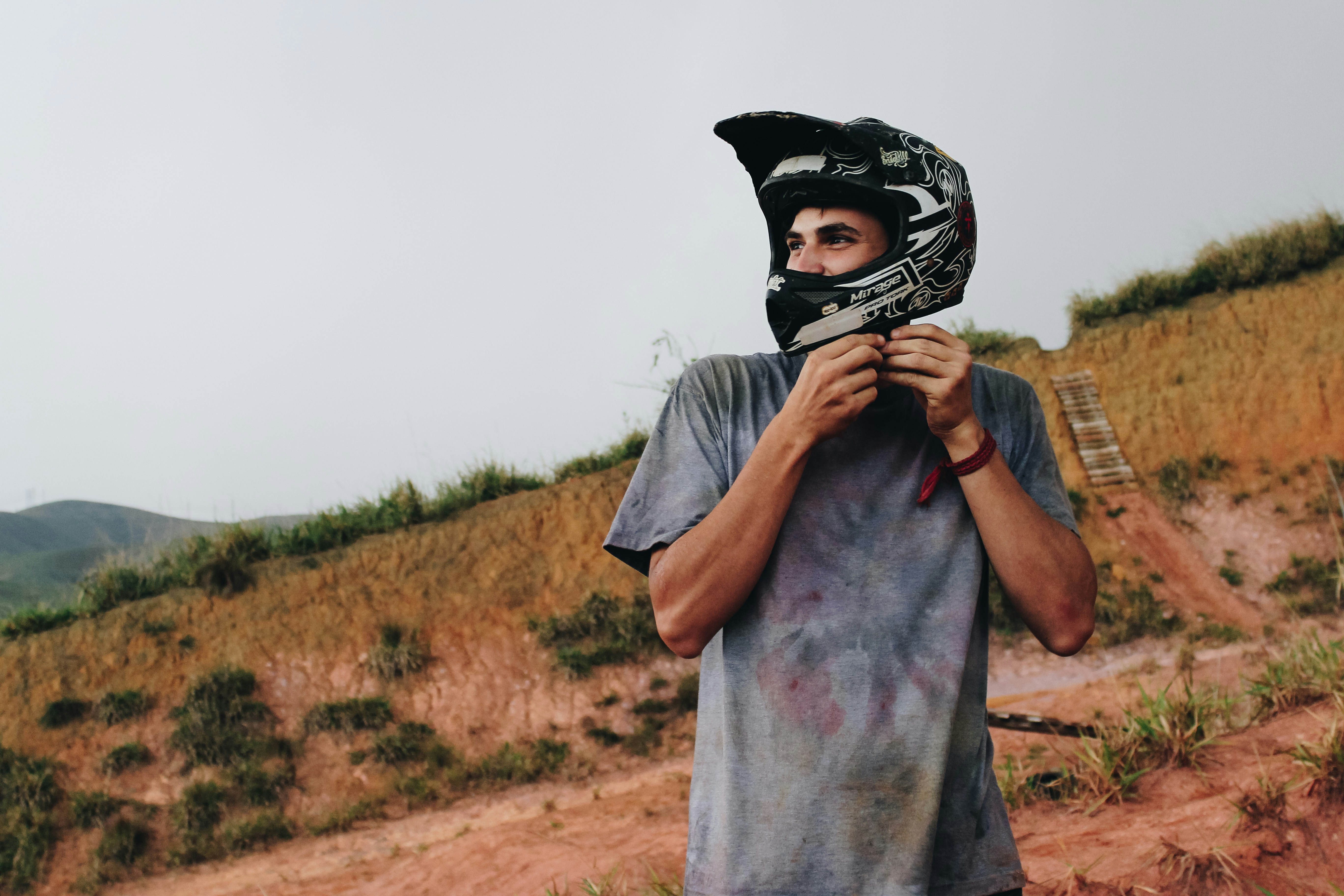 shallow focus photo of man wearing off-road motorcycle helmet