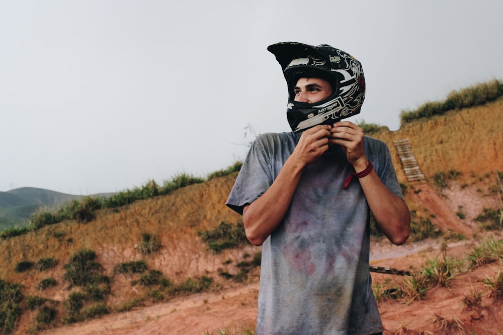 shallow focus photo of man wearing off-road motorcycle helmet