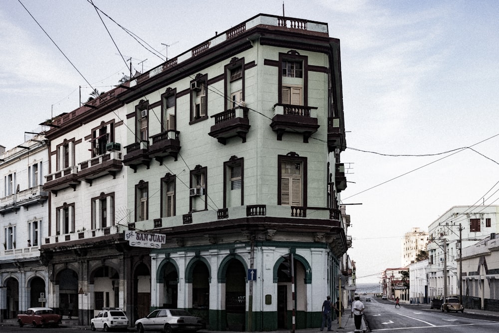 a large white building sitting on the side of a road