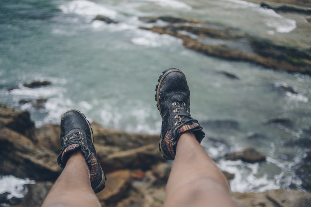 person wearing black hiking boots