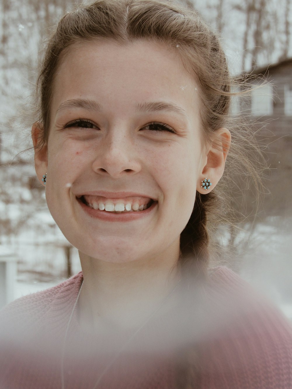 smiling woman in pink sweater on selective focus photography