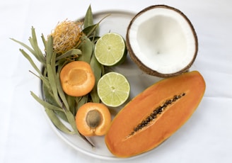 sliced fruits served on white plate