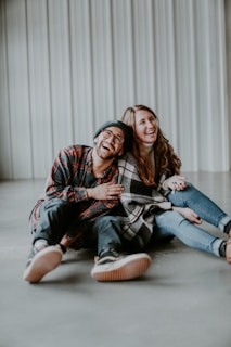 smiling woman and man sitting on floor
