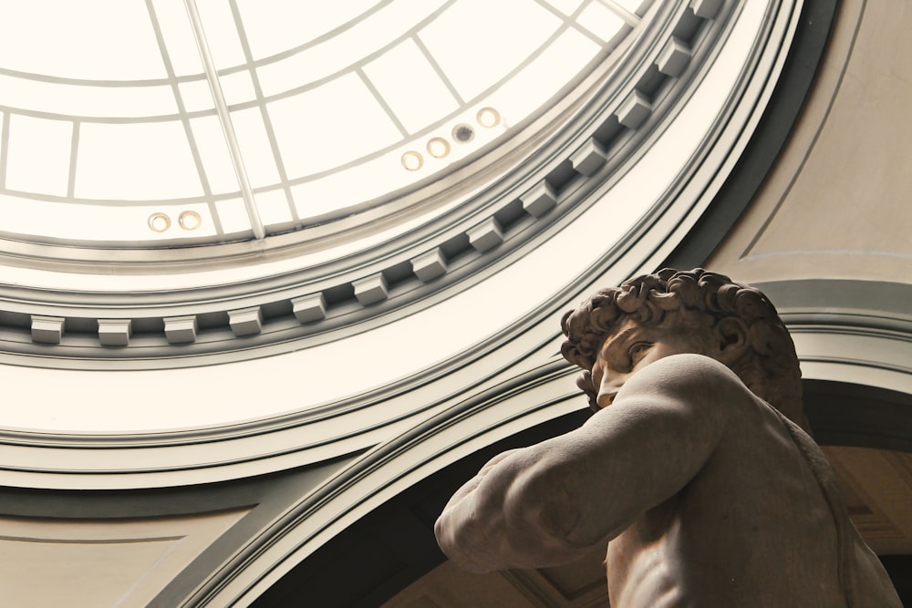 man themed statue inside dome building