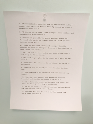 A piece of white paper is pinned to a light blue wall with a clear thumbtack. The paper contains a list of typed quotes, numbered from 1 to 13, each with a unique philosophical or motivational message.