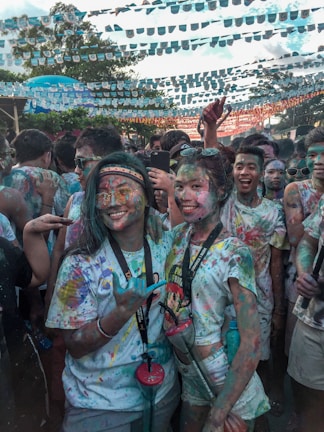 A group photo of grassroots party members celebrating a successful public event under colorful decorations.