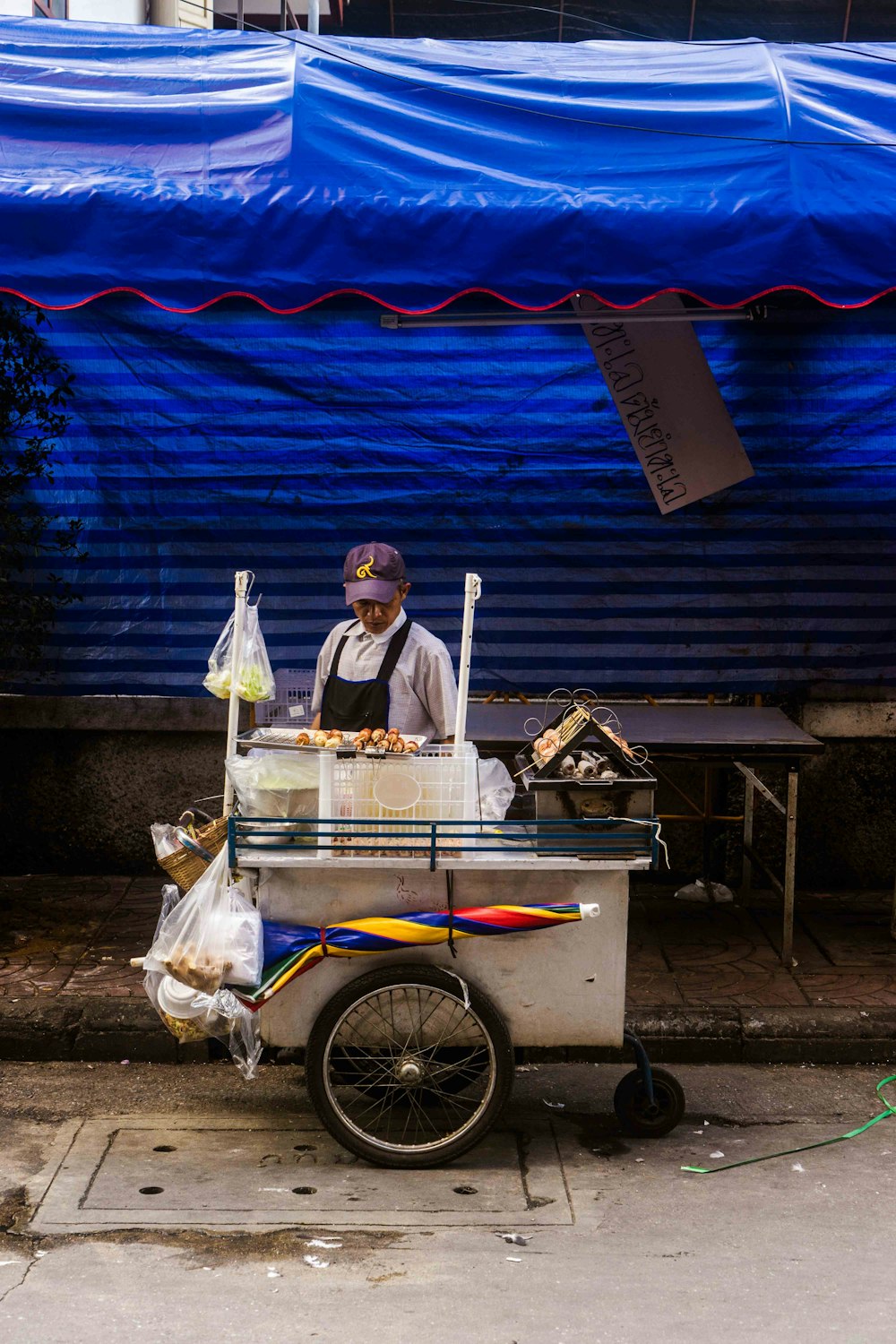 man standing in front of ice cream stall