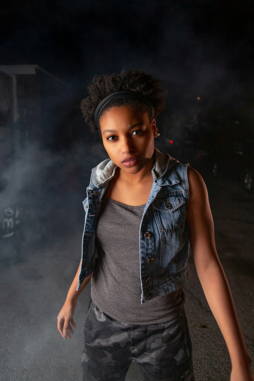 girl wearing blue denim vest standing