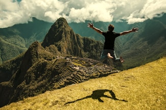man jumping in green open field
