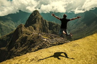 man jumping in green open field