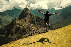 man jumping in green open field
