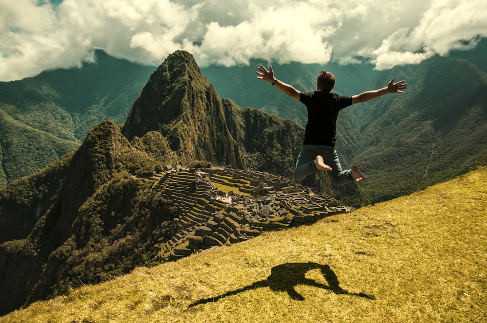 man jumping in green open field