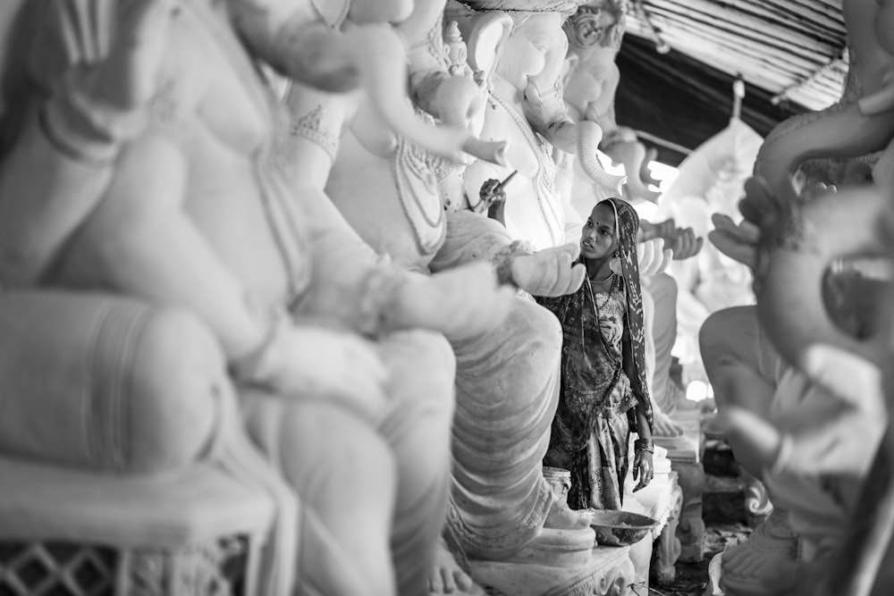 a black and white photo of a group of statues