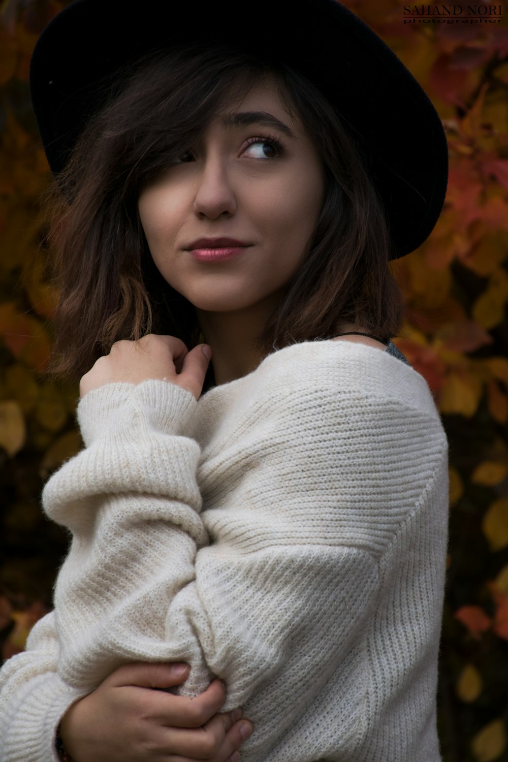 woman wearing hat and white sweatshirt