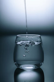 clear drinking glass on gray surface