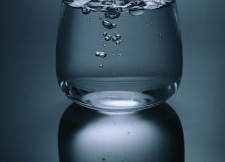 clear drinking glass on gray surface