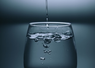 clear drinking glass on gray surface