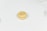 A single macaron on a light, plain background with 'maid of honor' written on top in cursive.