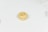 A single macaron on a light, plain background with 'maid of honor' written on top in cursive.