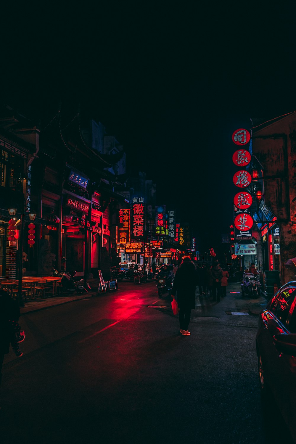 person standing beside road during nightime